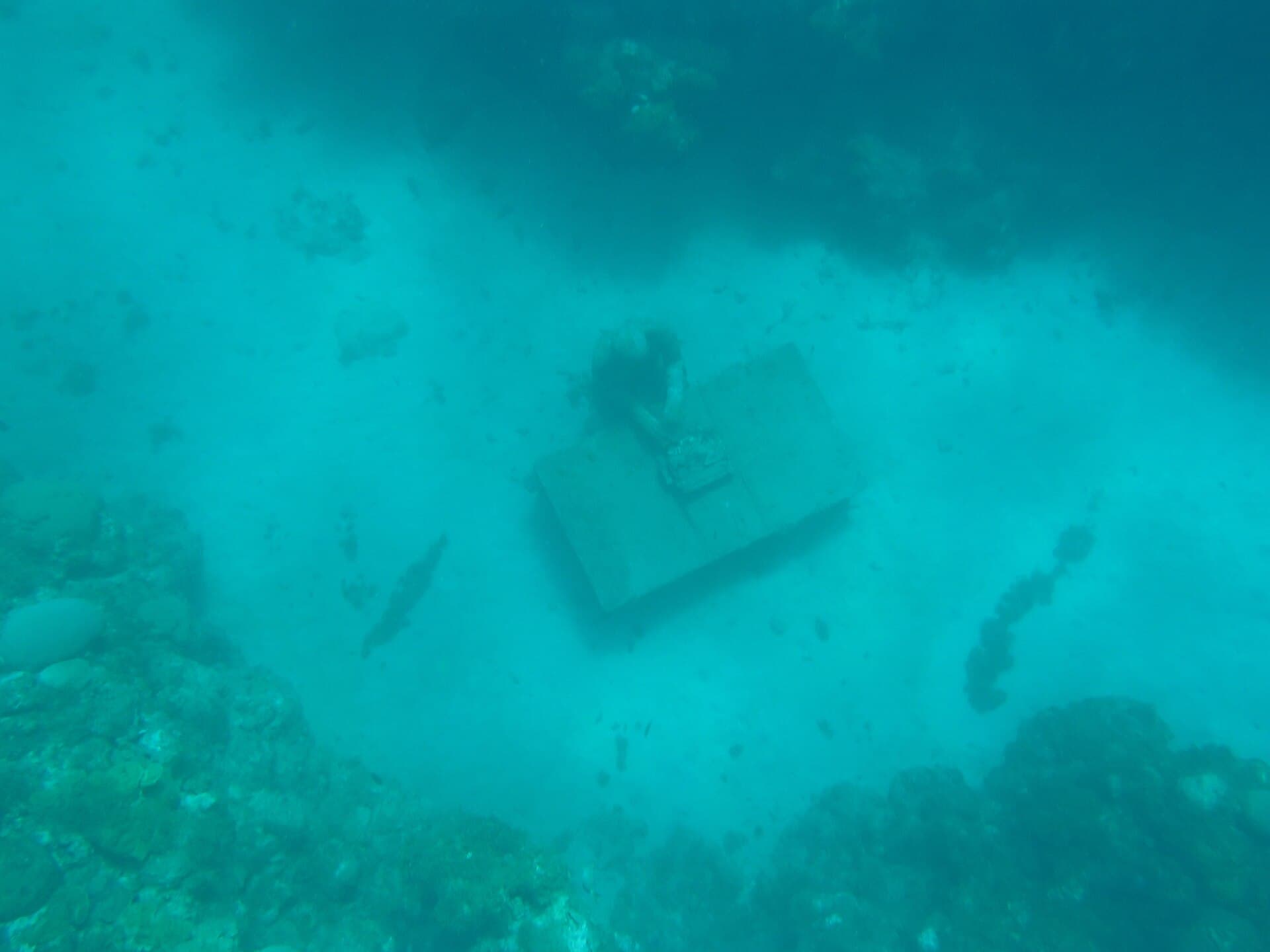 A seated figure at a desk on the seabed at Molinere Underwater Sculpture Park, Grenada